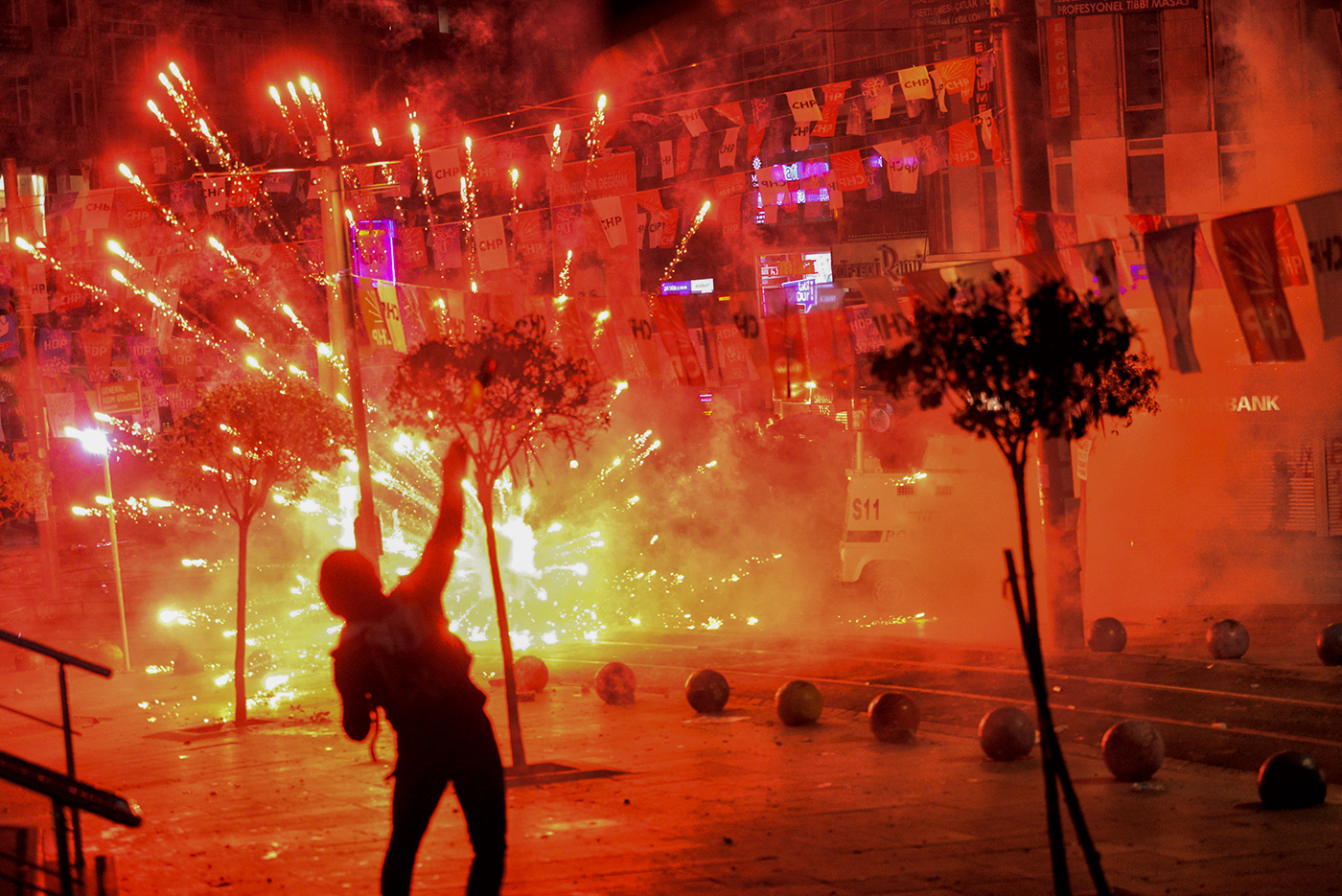 Fireworks thrown by protesters against Turkish riot police explode and illuminate the scene during a demonstration in Istanbul, Turkey, 11 March 2014.