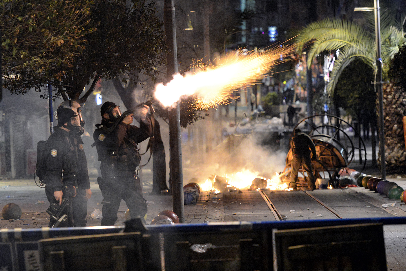 Turkish riot police fires tear gas to disperse protesters during a demonstration after 15 years old Berkin Elvan dead who was dead after struck on the head by a police tear gas in Istanbul, Turkey, 11 March 2014.
