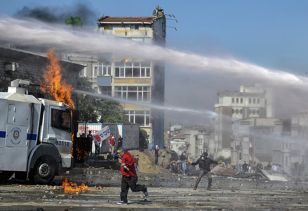 A burning Turkish police water cannon vehicle during a clashes at an anti-government protest near Taksim Square in Istanbul, Turkey, 11 July 2013