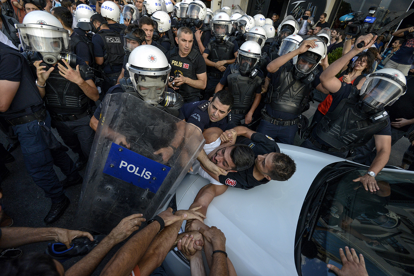 Protestors hold their friend hand as Turkish police detain him during a anti government protest in Istanbul, Turkey, 31 June 2020.