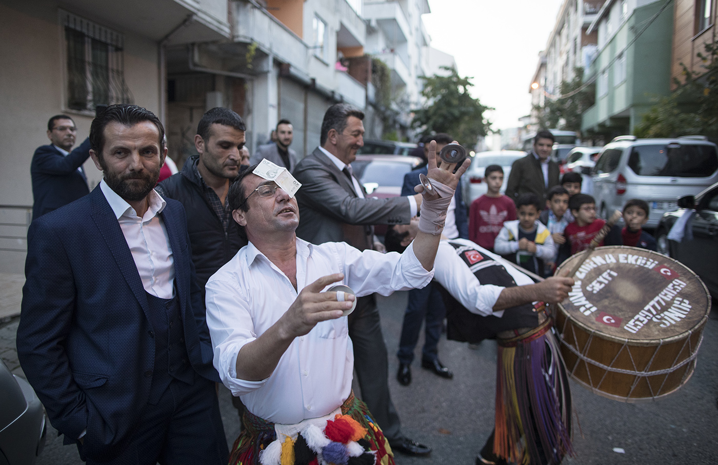 Osman Celik (C) dance with money which is given by people on his head during a wedding in Istanbul, Turkey, 16 November 2019. 