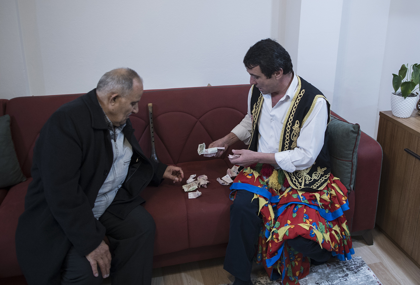 Osman Celik (R) counts money for share with musicians after a entertainment of a boy which will do soon compulsory military service in Istanbul, Turkey, 01 December 2019. 