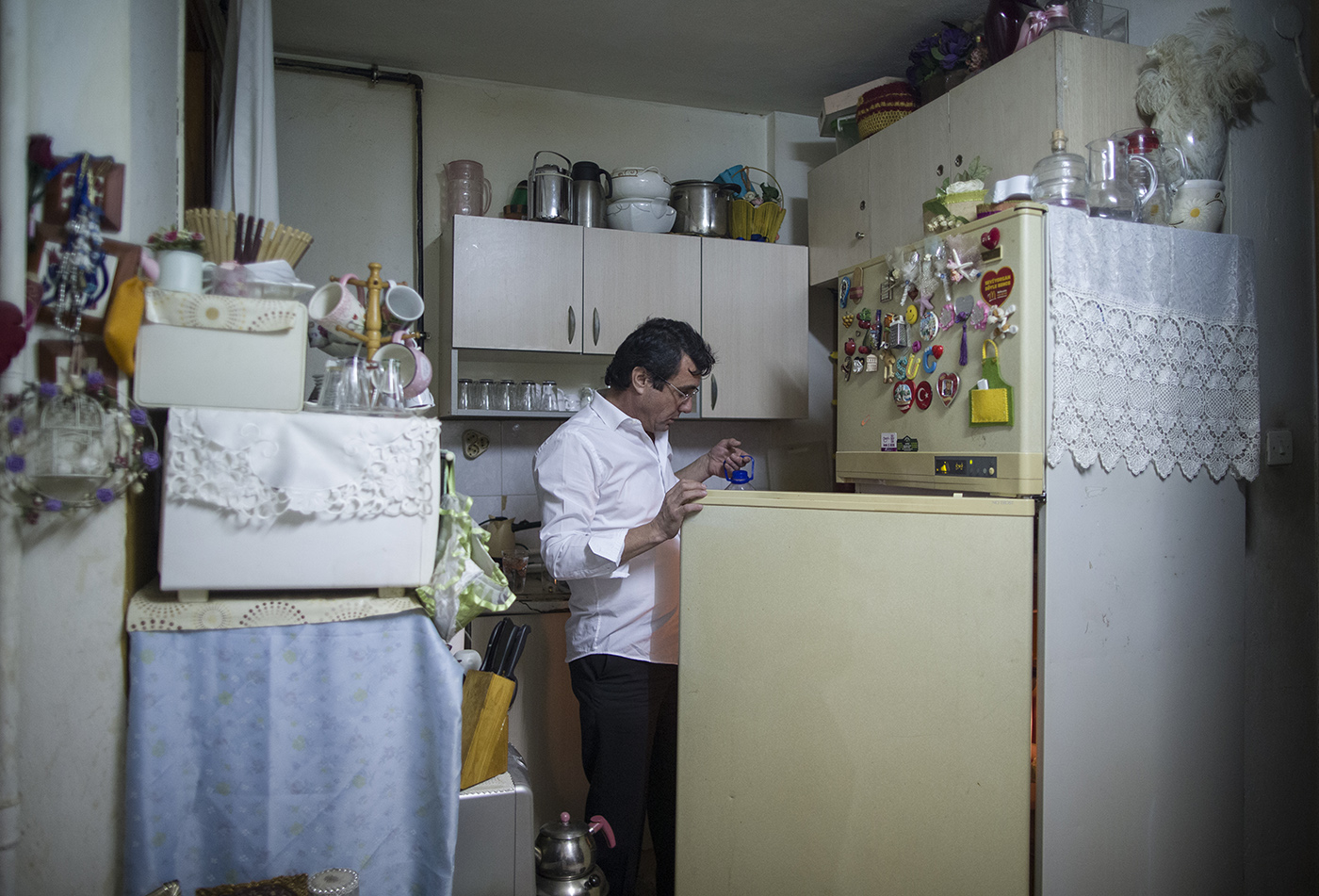 Osman Celik checks his refrigerator at his home in Istanbul, Turkey, 21 December 2019. 