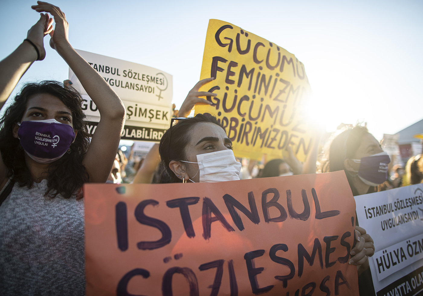 Women wearing face mask hold placards and shot slogans during prevention of violence against women rally in Istanbul, Turkey, 05 August 2020.