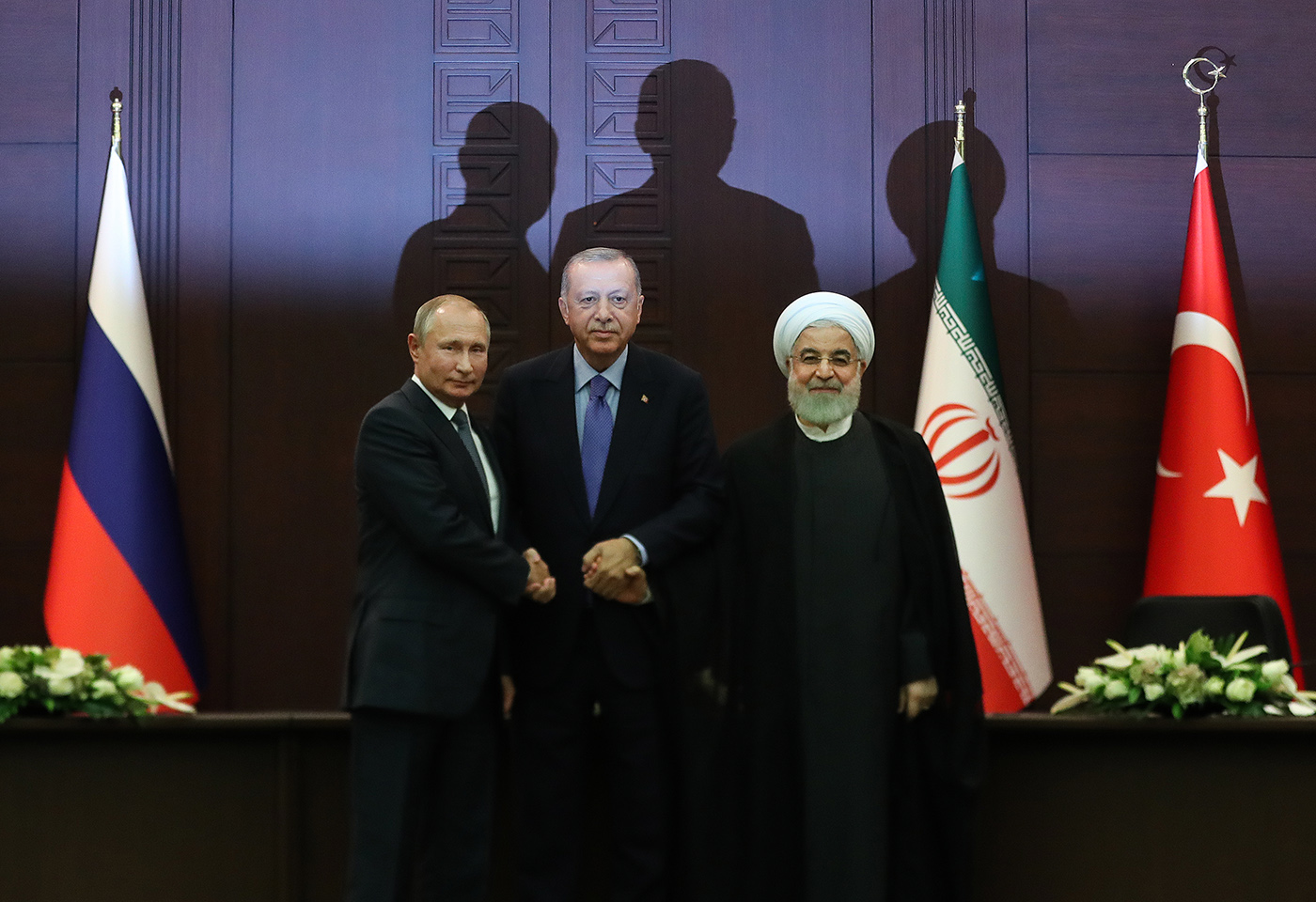 Turkish President Recep Tayyip Erdogan (C), Russian President Vladimir Putin (L) and Iranian President Hassan Rouhani (R) pose for media during a press conference after their summit in Ankara, Turkey, 16 September 2019.