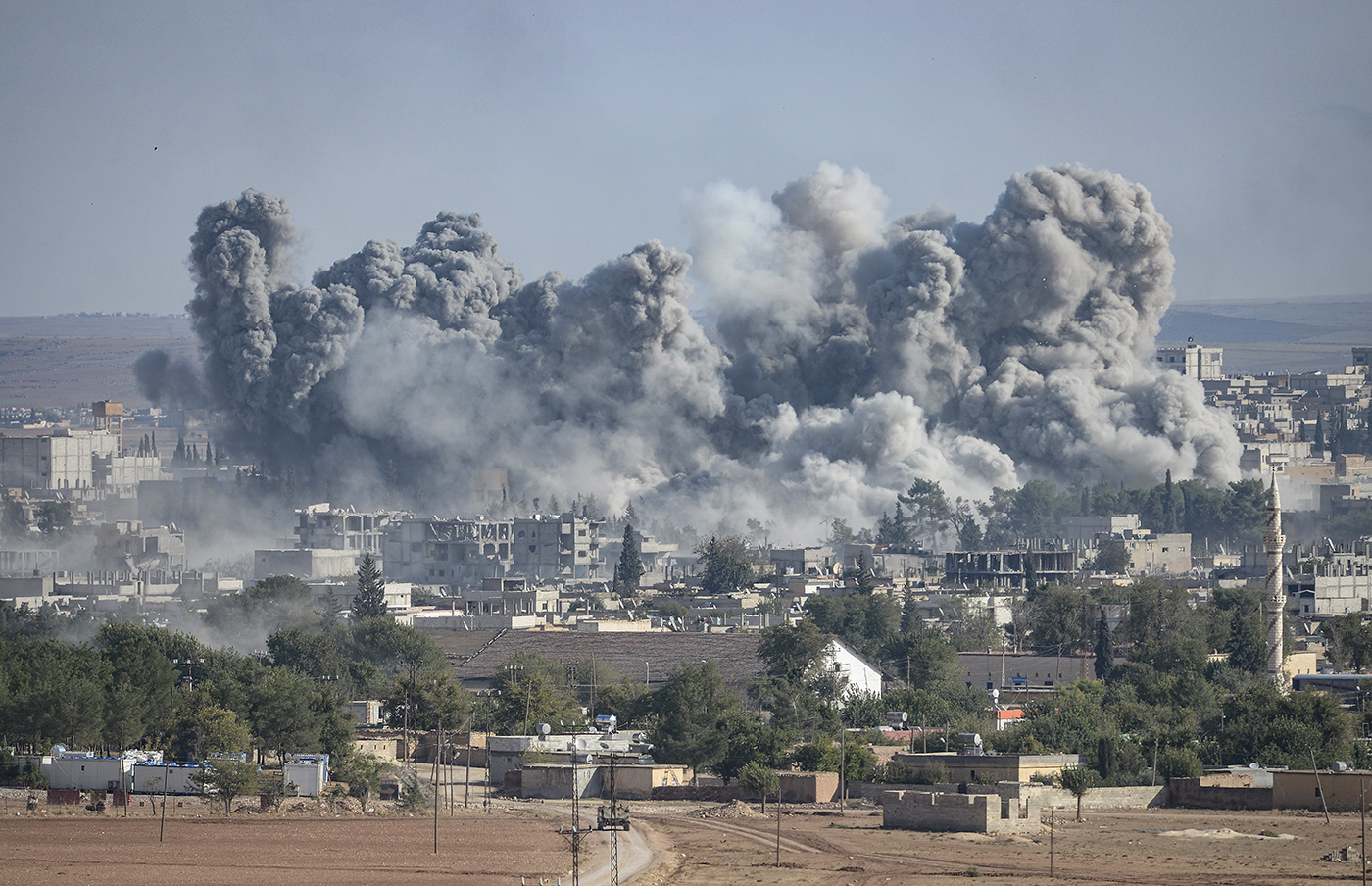 An explosion after an apparent US-led coalition airstrike on Kobane, Syria, as seen from the Turkish side of the border, near Suruc district, Sanliurfa, Turkey, 18 October 2014.