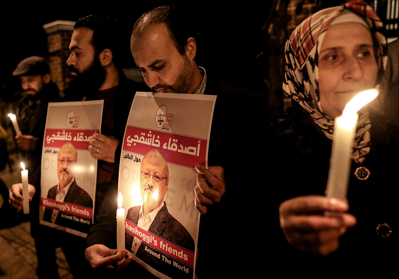 Protestors hold candles and pictures of Jamal Khashoggi during the demonstration in front of Saudi Arabian consulate in Istanbul, Turkey, 25 October 2018.