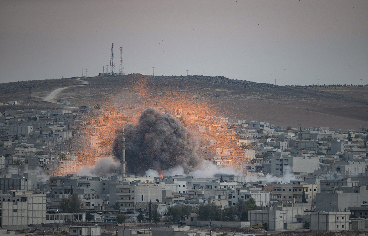 An explosion after an apparent US-led coalition airstrike on Kobane, Syria, as seen from the Turkish side of the border, near Suruc district, Sanliurfa, Turkey, 18 October 2014.