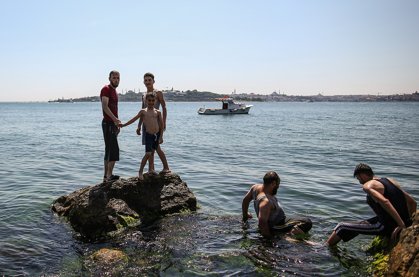 Syrian refugees cool off in the sea to beat the scorching heat during a sunny day in the Bosphorus Strait, Istanbul, Turkey, 08 June 2019.