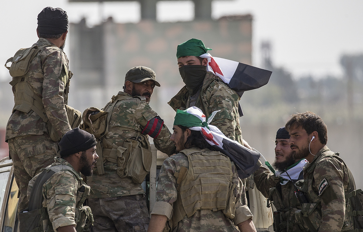 Turkish-backed Syrian fighters move on the way to Northern Syria for a military operation in Kurdish areas, near the Syrian border, in Akcakale district in Sanliurfa, Turkey, 15 October 2019.