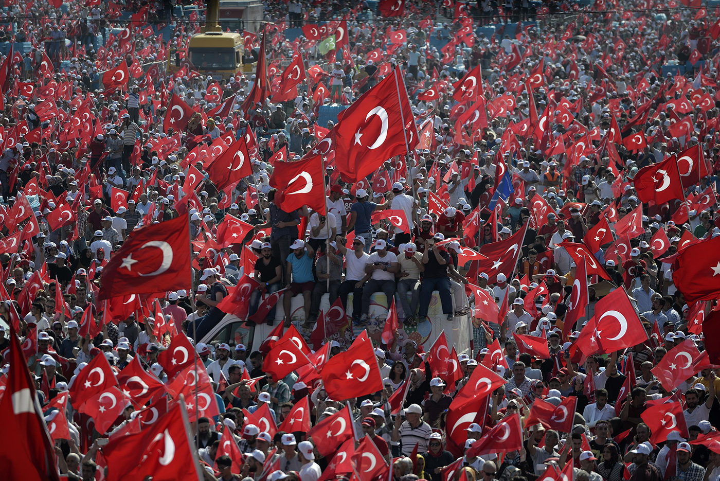People hold Turkish flags during a rally after a coup attempt in Istanbul, Turkey, 7 August 2016.