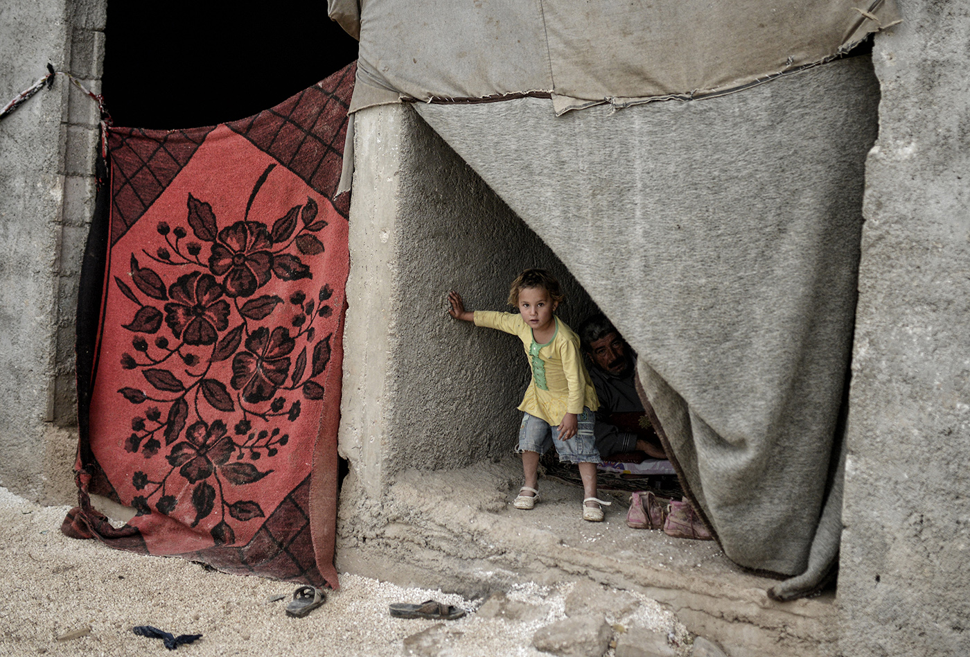 A Syrian refugee girl looks from their shed in Sanliurfa, Turkey, 16 October 2014.
