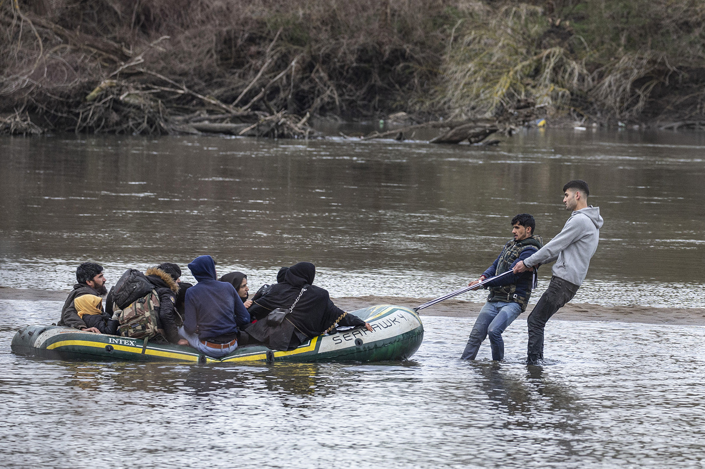 Refugees boat sails on the Meric river for pass to Greek border as they try to enter Europe, in Edirne, Turkey, 29 February 2020. 