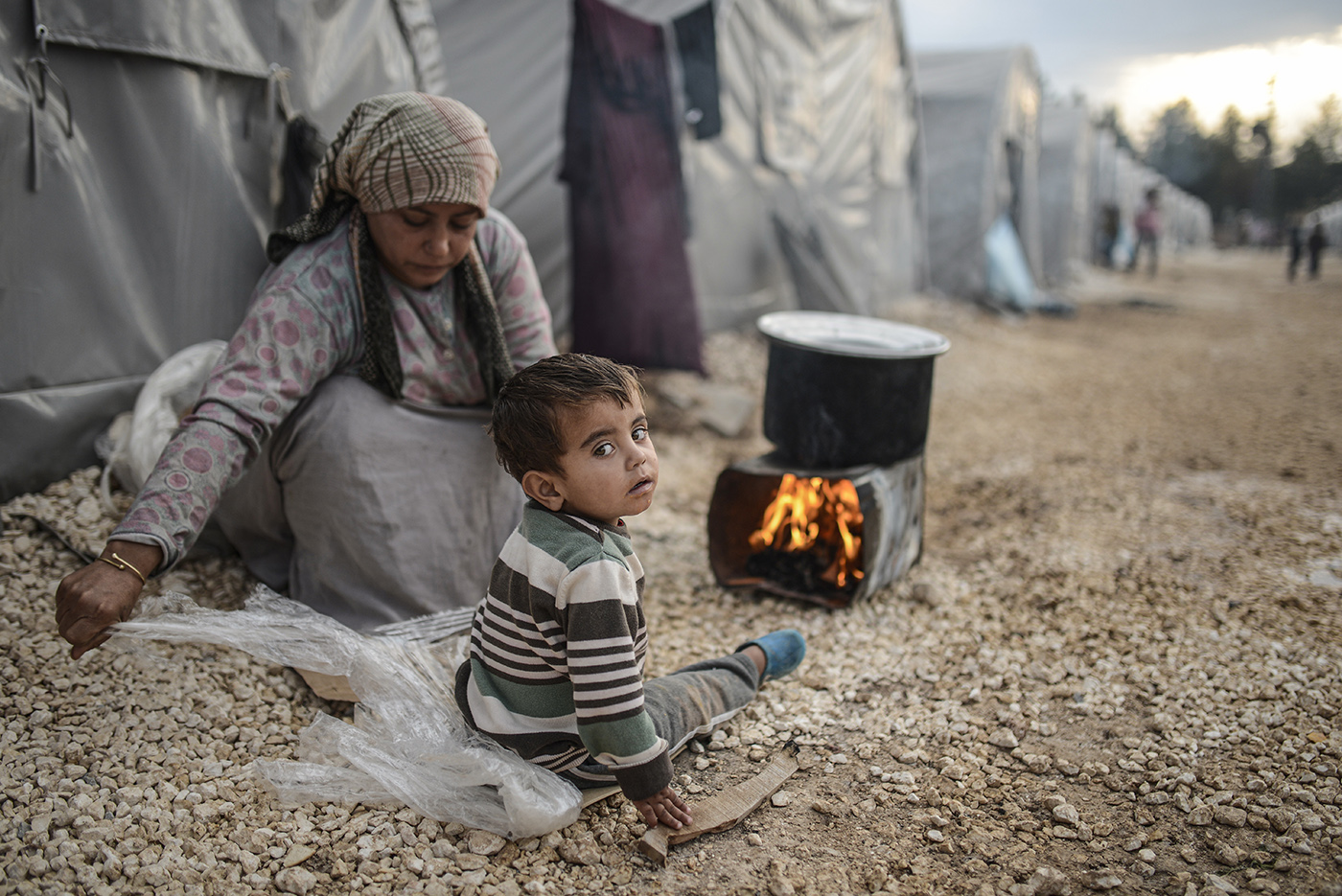 Syrian refugees sit in front of their tent at the refugee camp in Sanliurfa, Turkey, 28 October 2014.