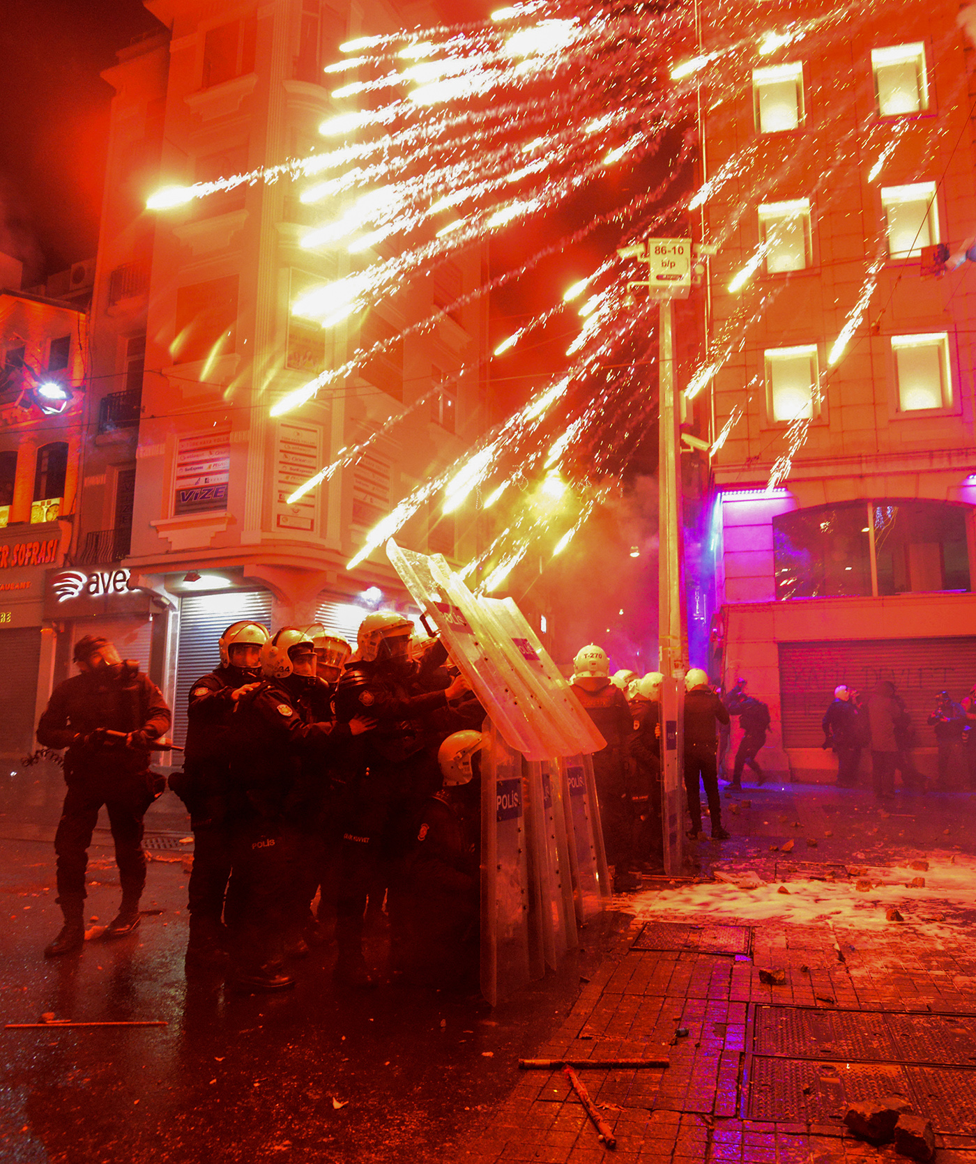 Turkish riot police takes cover behind their shields as firework shot by protesters explodes in front of them during clashes within an anti government protest against new internet bans, in Istanbul, Turkey, 08 February 2014.