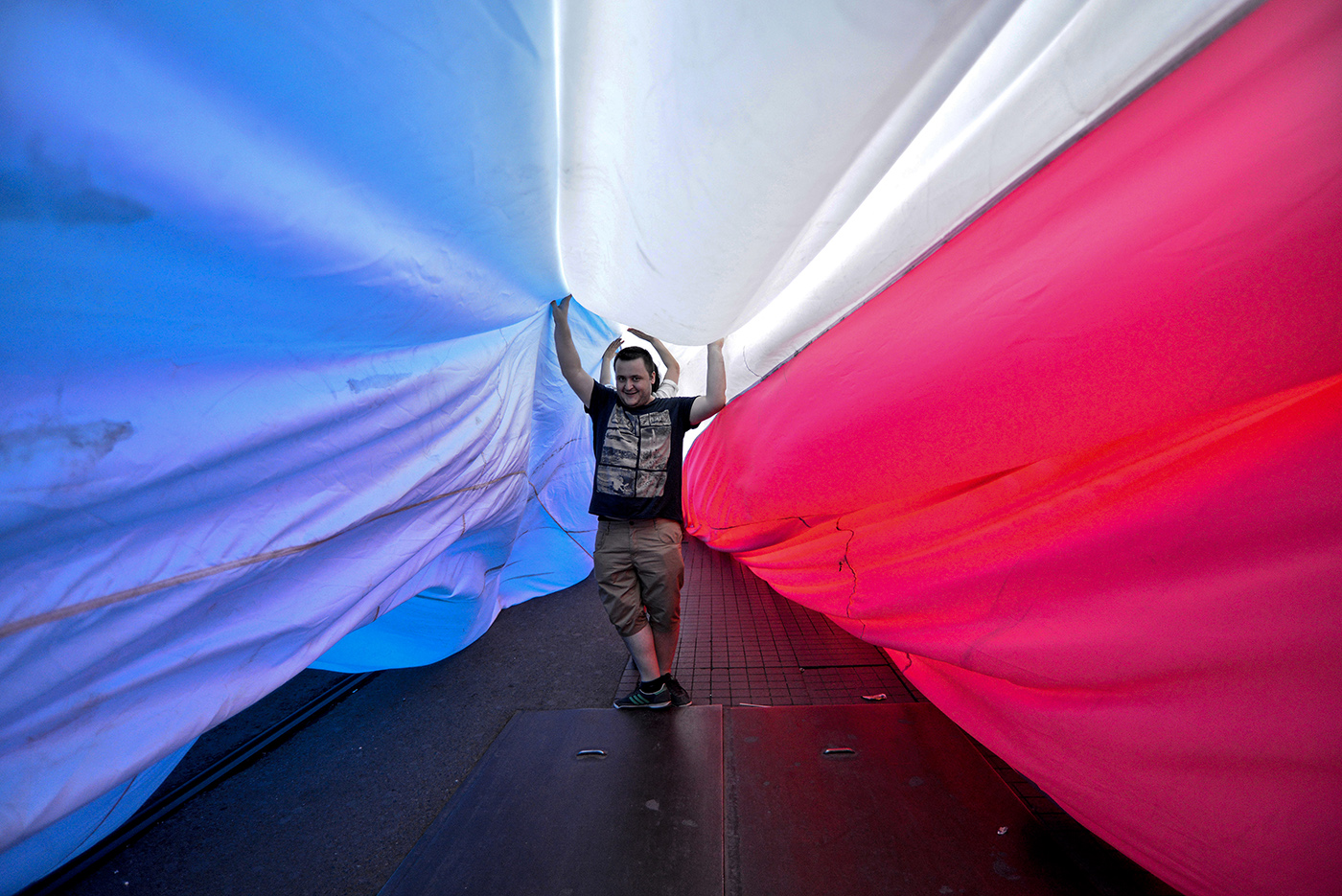 People walk under a gigantic rainbow flag as they participate in the 6th Istanbul LGTB Pride Parade in Istanbul, Turkey, 21 June 2015. Hundreds of transgender people and supporters marched in central Istanbul as part of the Trans Pride Week 2015, which is organized by Istanbul