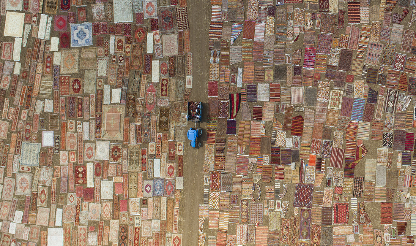 Thousands of hand knotted Turkish carpets lay in fields owned by carpet companies at Dosemealti district in Antalya, Turkey, 10 August 2018. Workers put on fields almost 30,000 of carpets to soften their colors, to become more pastel under the sun in Antalya city. Carpet weaving tradition in Turkey has a long history dated back to ancient times.