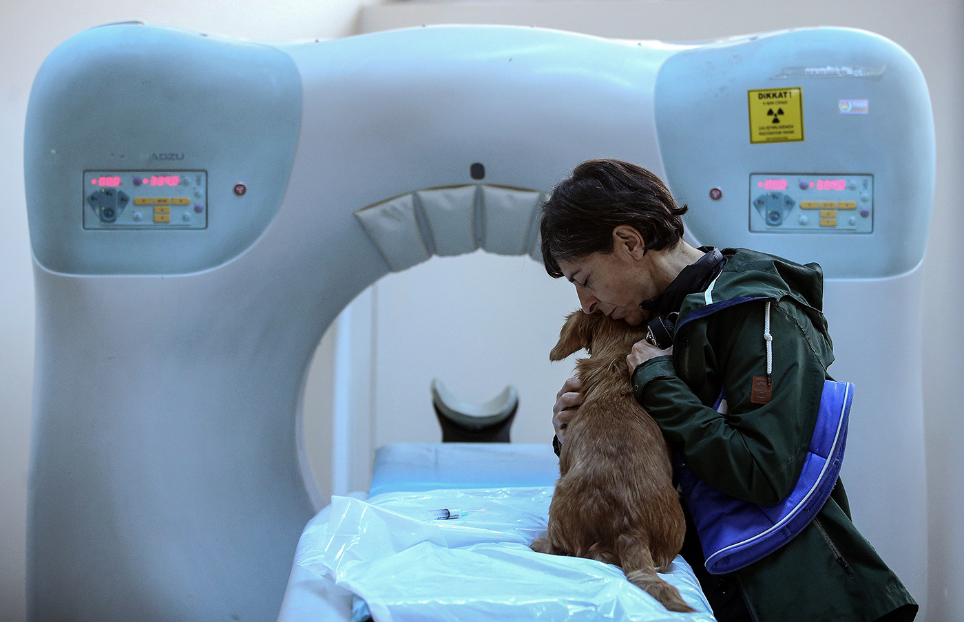 A woman hugs her dog before it gets a narcosis for tomography screening at the Istanbul University Cerrahpasa Faculty of Veterinary Science Hospital in Istanbul, Turkey, 13 December 2018.
