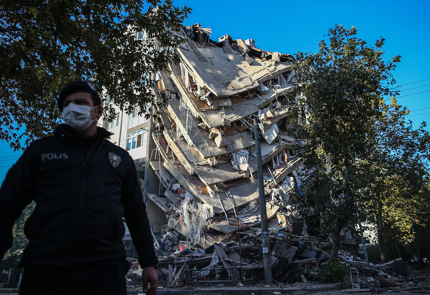 A Turkish police secure the area in front of a collapsed building after a 7.0 magnitude earthquake in the Aegean Sea, at Bayrakli district in Izmir, Turkey, 01 November 2020. According to Turkish media reports, at least forty nine people died while more than eight  hundreds were injured and dozens of buildings were destroyed in the earthquake.