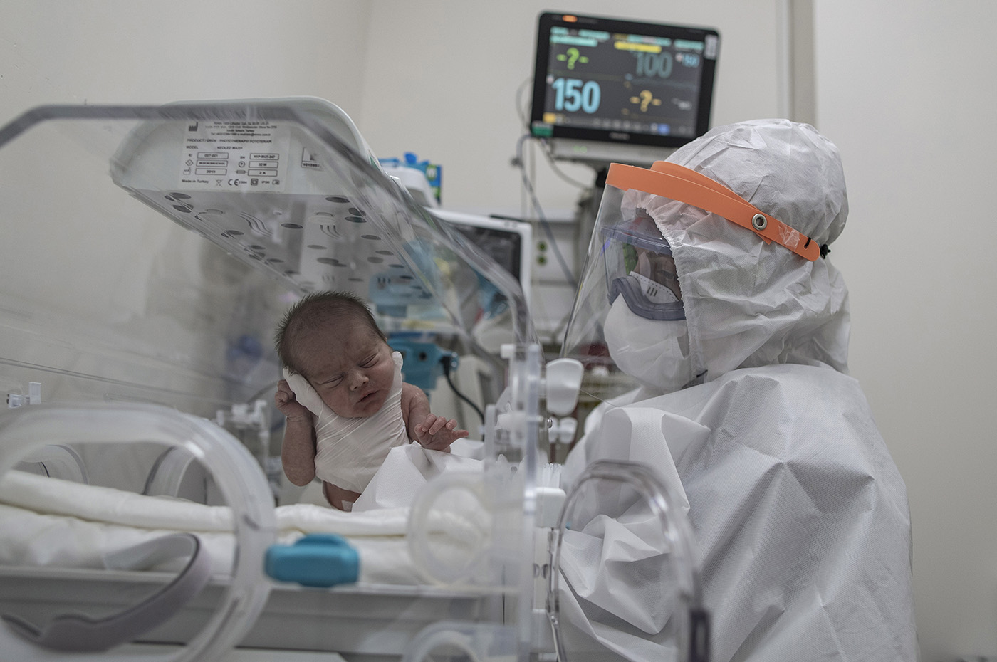 A medical worker wearing Personal Protective Equipment (PPE) feeds to a new born baby from a positive COVID-19 mother at the Sancaktepe Martyr Prof Dr Ilhan Varank Training and Research Hospital in Istanbul, Turkey, 11 May 2020. 60.000 people have applied with suspicion of COVID-19 until 11 May 2020 to Sancaktepe hospital. 12.000 of these tested and 2500 treated. Hospital mortality rate is below 1%.