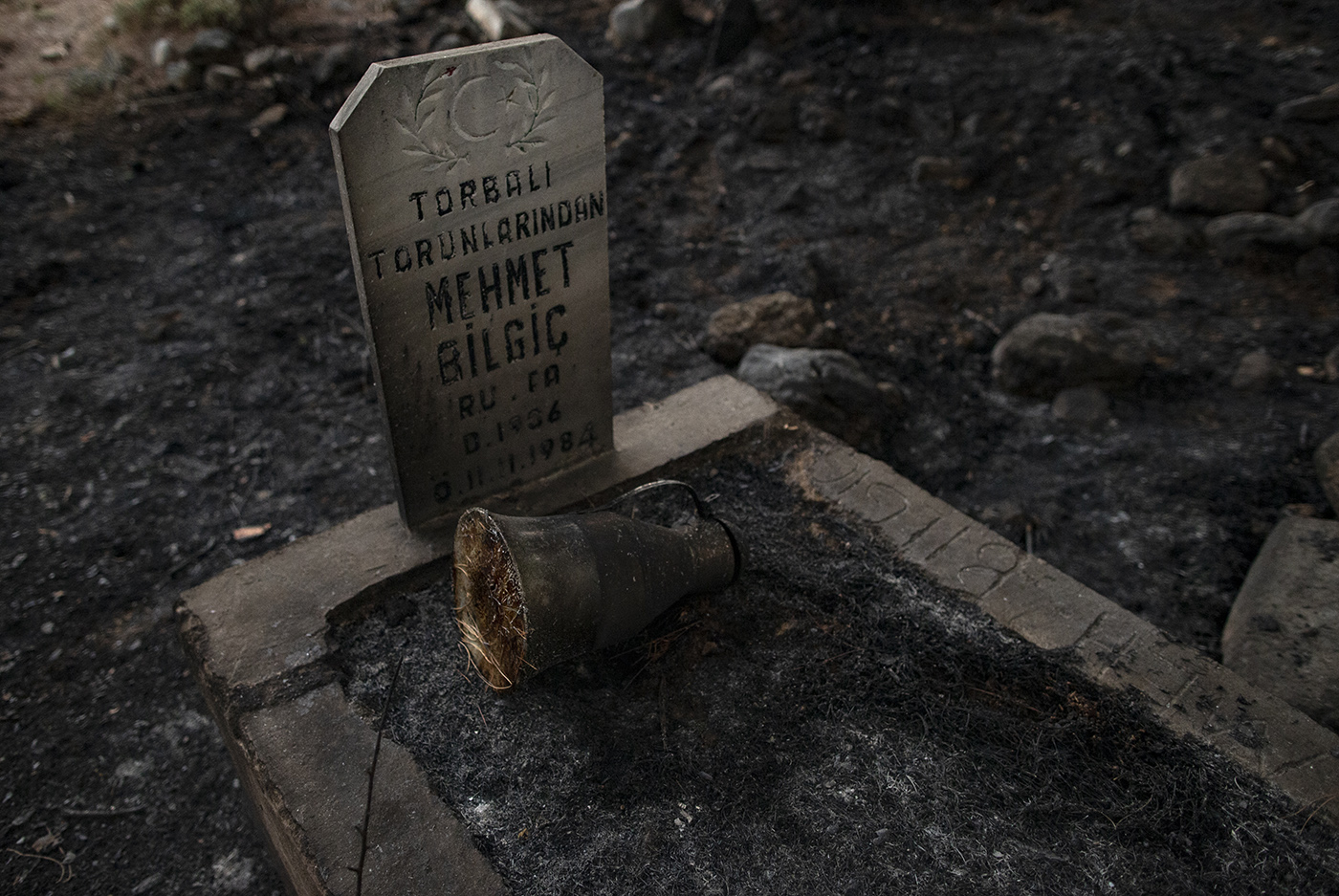 A burnt grave at the Yuvarlakcay village of the Koycegiz district of Mugla, Turkey, 03 August 2021. Turkish Health minister Fahrettin Koca confirmed that eight people have lost their lives due to the wildfires raging in Turkey’s Mediterranean towns.