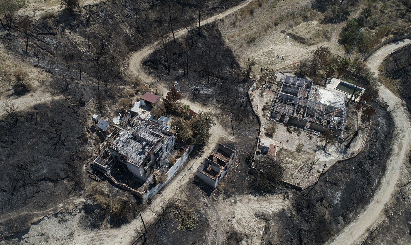 An aerial view taken with a drone shows burned houses after a wildfire at the Kalemler village of the Manavgat district of Antalya, Turkey, 09 August 2021.