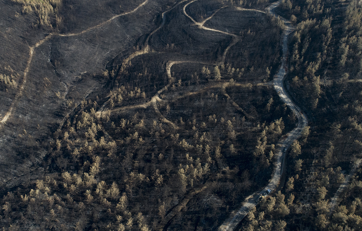 An aerial view taken with a drone shows burned lands after a wildfire at the Manavgat district of Antalya, Turkey, 10 August 2021.