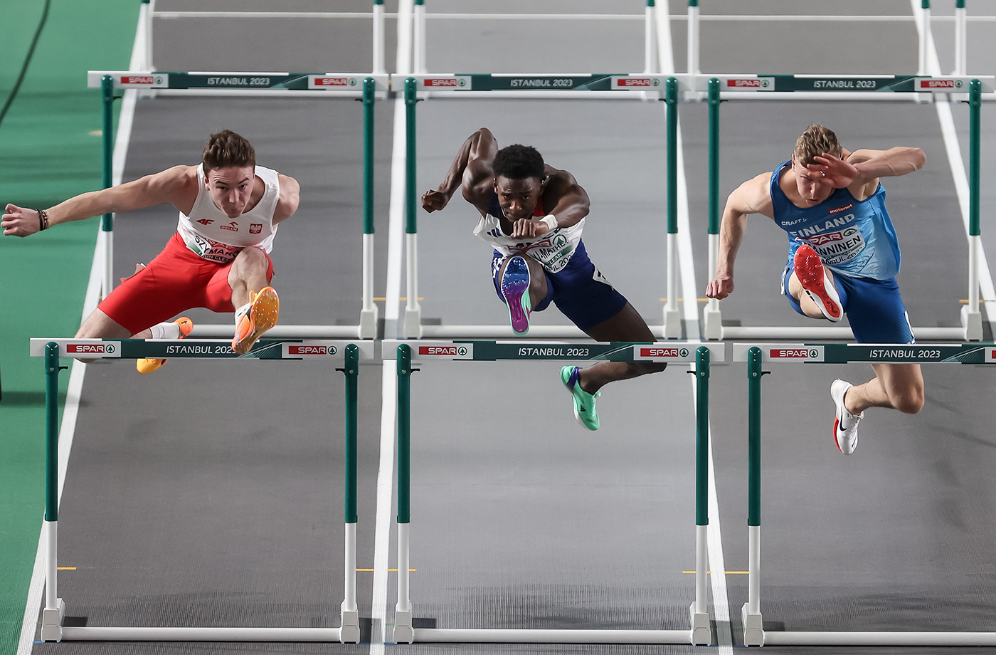 Jakub Szymanski of Poland (L), Just Kwaou-Mathey of France (C) and Ilari Manninen of Finland (R) in action during a 60m Hurdles Men Heat run at the European Athletics Indoor Championships in Istanbul, Turkey, 04 March 2023.