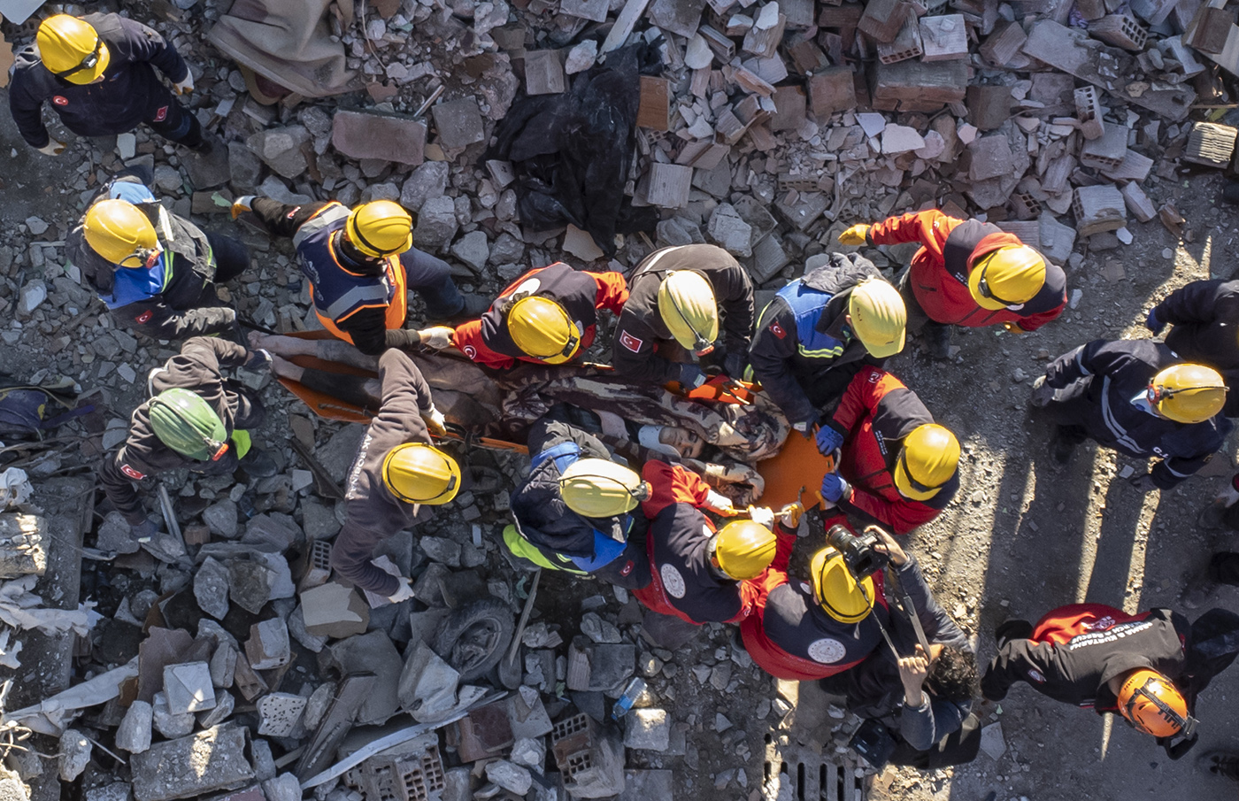 A photo taken with a drone shows carry a survivor who was rescued from a site of a collapsed building after 60 hours an earthquake in Hatay, Turkey, 08 February 2023. Thousands of people died and thousands more were injured after major earthquakes struck southern Turkey and northern Syria on 06 February. Authorities fear the death toll will keep climbing as rescuers look for survivors across the region.