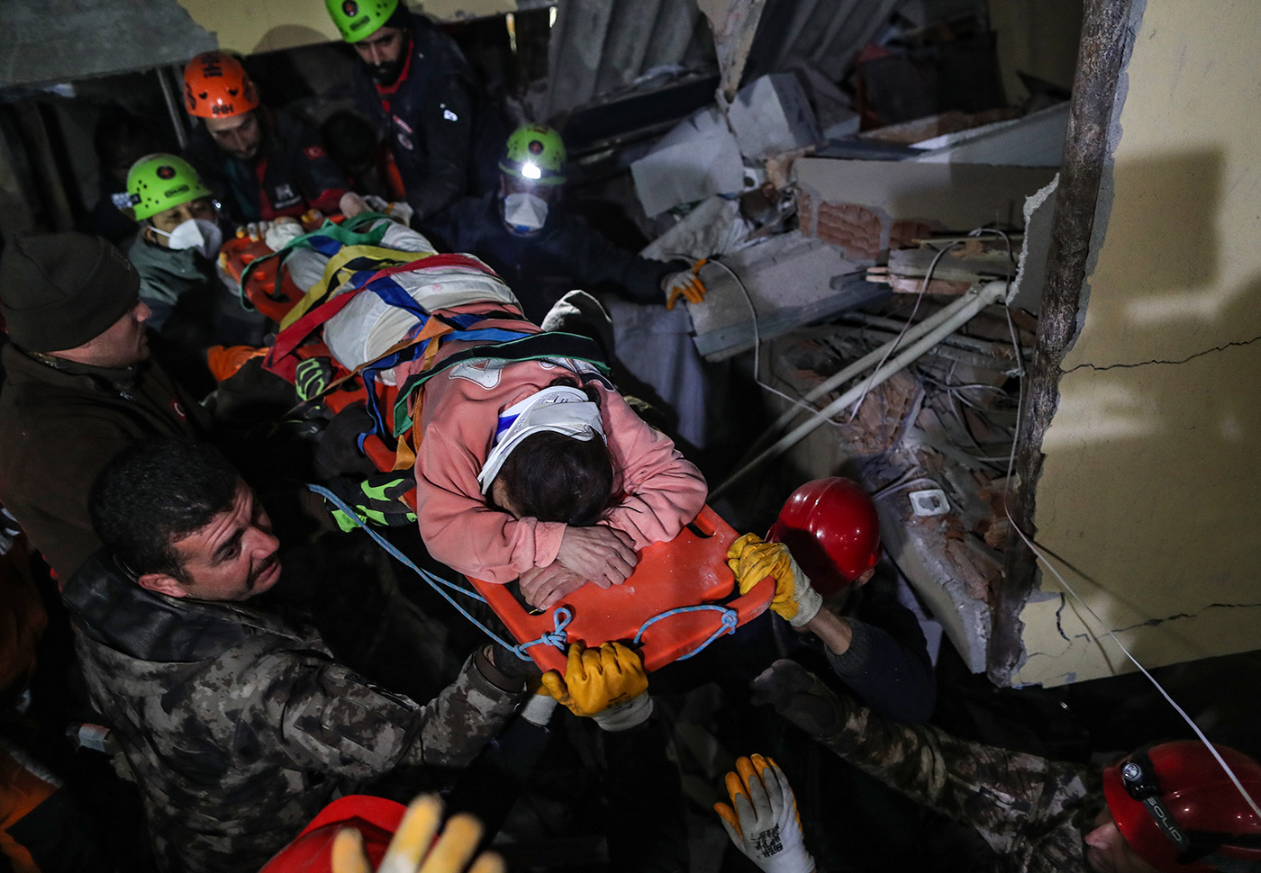 Rescue team members carry Hulya Kabakulak after they evecuated her from a collapsed building after 90 hours in the aftermath of a powerful earthquake in Hatay city, southeastern Turkey, 09 February 2023. More than 17,000 people have died and thousands more are injured after two major earthquakes struck southern Turkey and northern Syria on 06 February. Authorities fear the death toll will keep climbing as rescuers look for survivors across the region. 